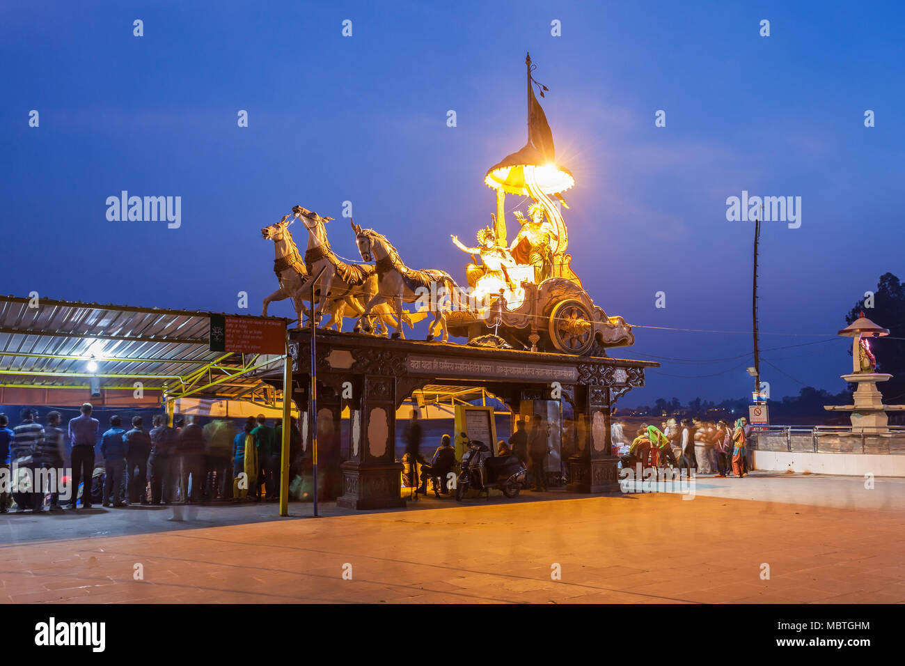 RISHIKESH, INDIA - NOVEMBER 08, 2015: A statue of the Hindu god Krishna and his devotee Arjuna in Rishikesh at night, North India. Stock Photo