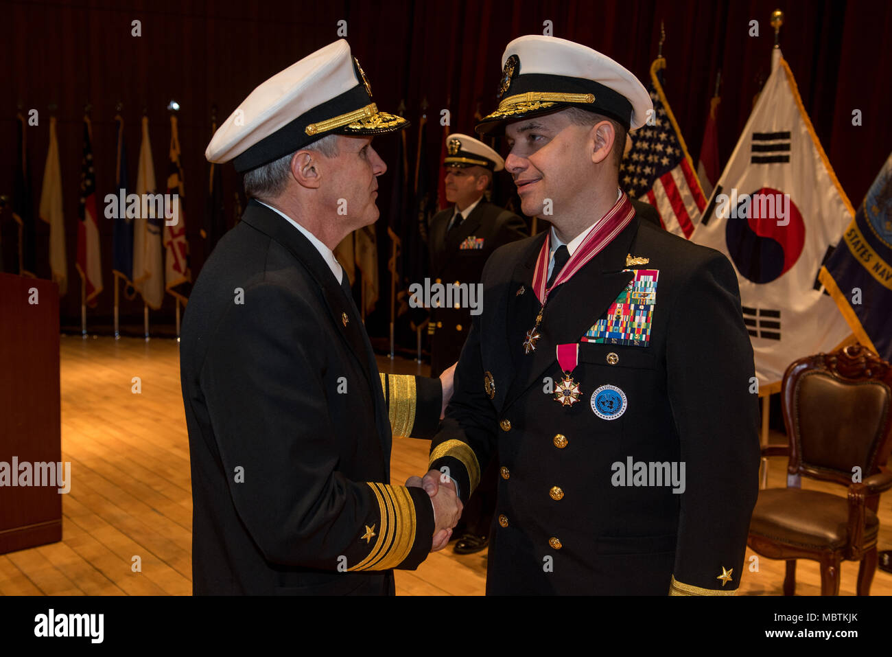 180111-N-TB148-107 Busan, Republic of Korea (Jan 11, 2018) - Vice Adm. Phil J. Sawyer, commander, U.S. Seventh Fleet presents the Legion of Merit to Rear Adm. Brad Cooper, commander, U.S. Naval Forces Korea (CNFK) during a change of command ceremony at CNFK headquarters. During the ceremony Rear Adm. Michael E. Boyle relieved Rear Adm. Brad Cooper, becoming CNFK’s 36th commander. (U.S. Navy photo by Mass Communication Specialist William Carlisle/ Released) Stock Photo