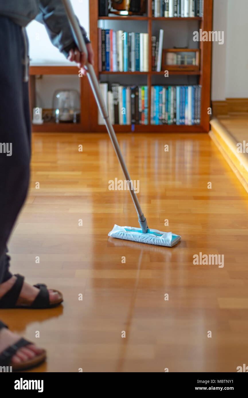 close up of a person polishing a wooden floor in their home Stock Photo