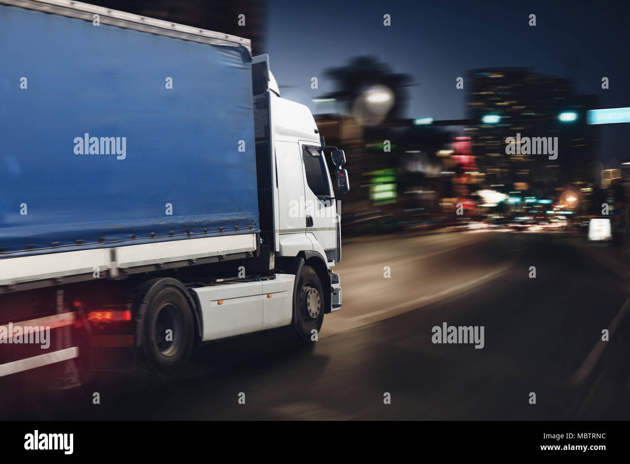 Fast truck on a city road delivering at night Stock Photo