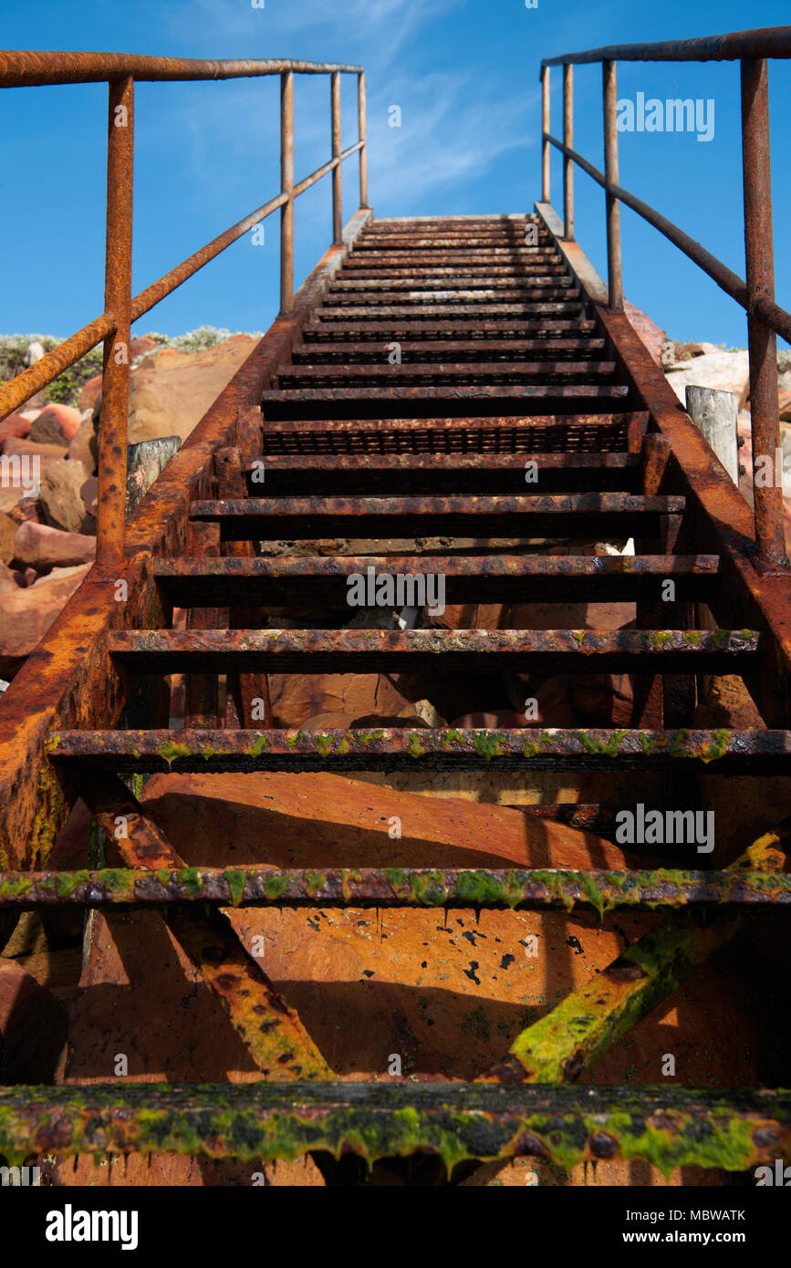 Rusty steps leading off the beach Stock Photo