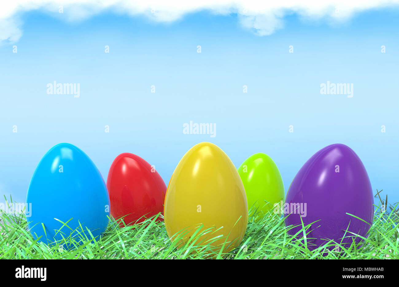 Easter colorful eggs in green grass and blue sky background with empty ...
