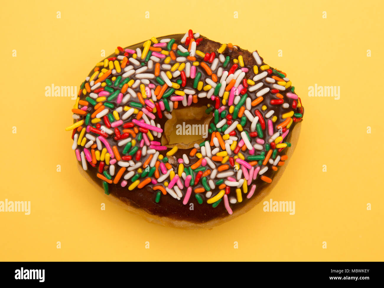 Sprinkle Donuts on a Yellow Background Stock Photo