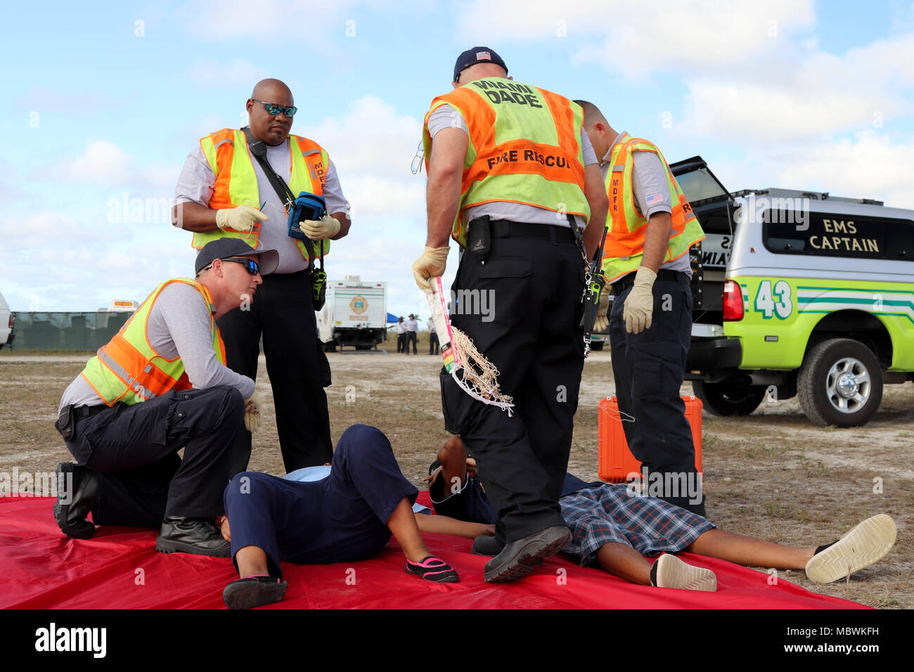 Members of the Miami-Dade Fire Department Fire and Rescue team, respond to the simulated injures of a volunteer during a Joint Training Exercise hosted by the Miami-Dade Fire Department and Homestead-Miami Speedway in Miami, Fla. Jan. 11, 2018. This JTE focused on building response capabilities and seamless the transition between the local first responders and the follow-on support provided by the National Guard and Active duty soldiers. (U. S. Army Photo by Spc. Samuel Brooks) Stock Photo