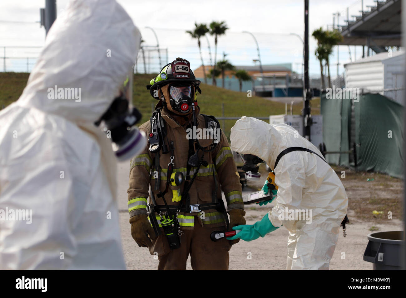 Lieutenant Jose Alfaro of the Miami-Dade Fire Department Hazmat team, holds still while being evaluated by a decontamination crew during a Joint Training Exercise hosted by the Miami-Dade Fire Department and Homestead-Miami Speedway in Miami, Fla. Jan. 11, 2018. This JTE focused on building response capabilities and seamless the transition between the local first responders and the follow-on support provided by the National Guard and Active duty soldiers. (U. S. Army Photo by Spc. Samuel Brooks) Stock Photo