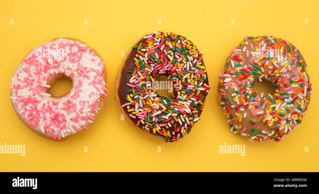 Sprinkle Donuts on a Yellow Background Stock Photo
