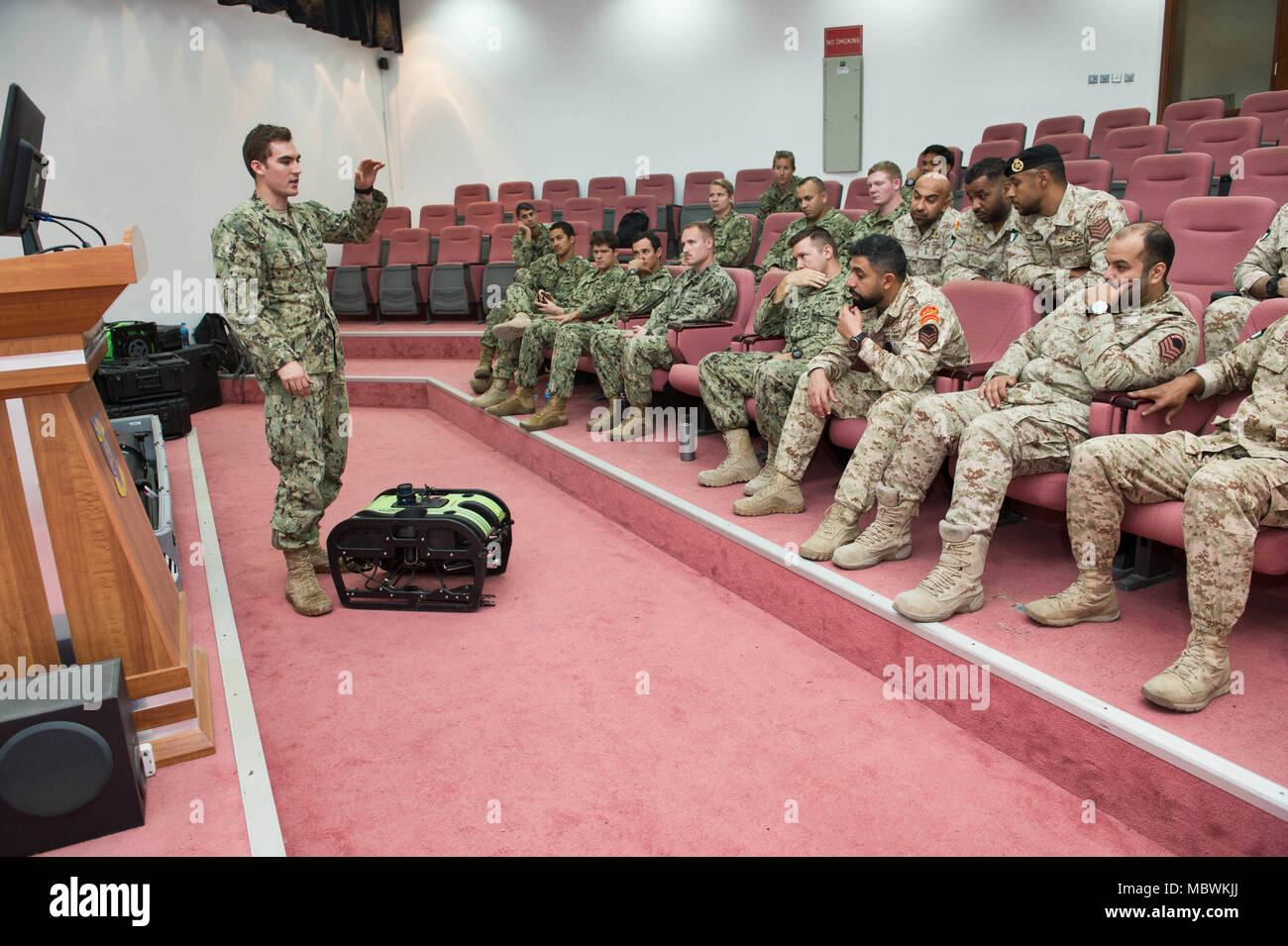 180107-N-XE158-0081 Mohammed Al-Ahmad Naval Base, KUWAIT (Jan. 7, 2018) Explosive Ordnance Disposal Technician 1st Class Kyle Hall, assigned to Commander, Task Group 56.1, explains the capabilities of the a remotely operated vehicle to Kuwait Naval Force explosive ordnance disposal technicians during a training evolution as part of exercise Eager Response 18. Eager Response 18 is a bilateral explosive ordnance disposal military exercise between the State of Kuwait and the United States. The exercise fortifies military-to-military relationships between the Kuwait Naval Force and U.S. Navy, adva Stock Photo