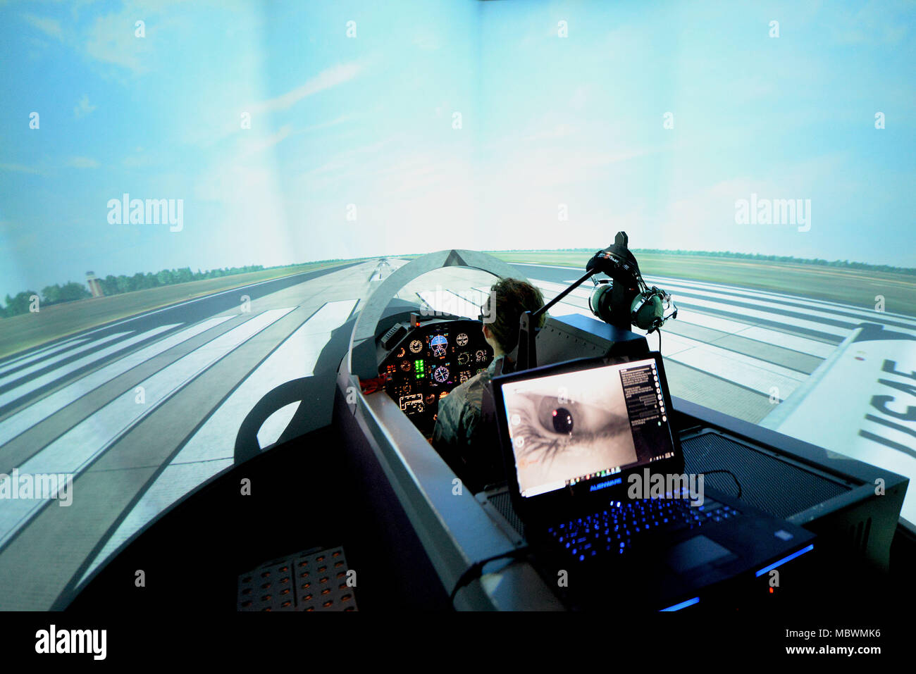 Second Lt. Madeline Schmitz, 14th Student Squadron student pilot, prepares to take flight in the T-6 Texan II flight simulator Jan 10, 2018, on Columbus Air Force Base, Mississippi. The Adaptive Flight Training Study here pushed subjects to learn through the virtual reality technology but used the T-6 flight simulator as a baseline to compare the other VR sorties to. This allowed researchers to see if the subject’s flights got better or worse after the VR flight training. (U.S. Air Force photo by Airman 1st Class Keith Holcomb) Stock Photo