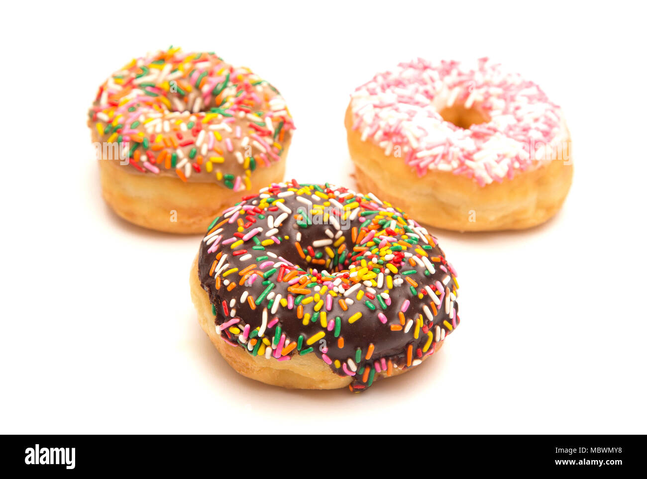 Various Flavored Sprinkle Donuts on a White Background Stock Photo