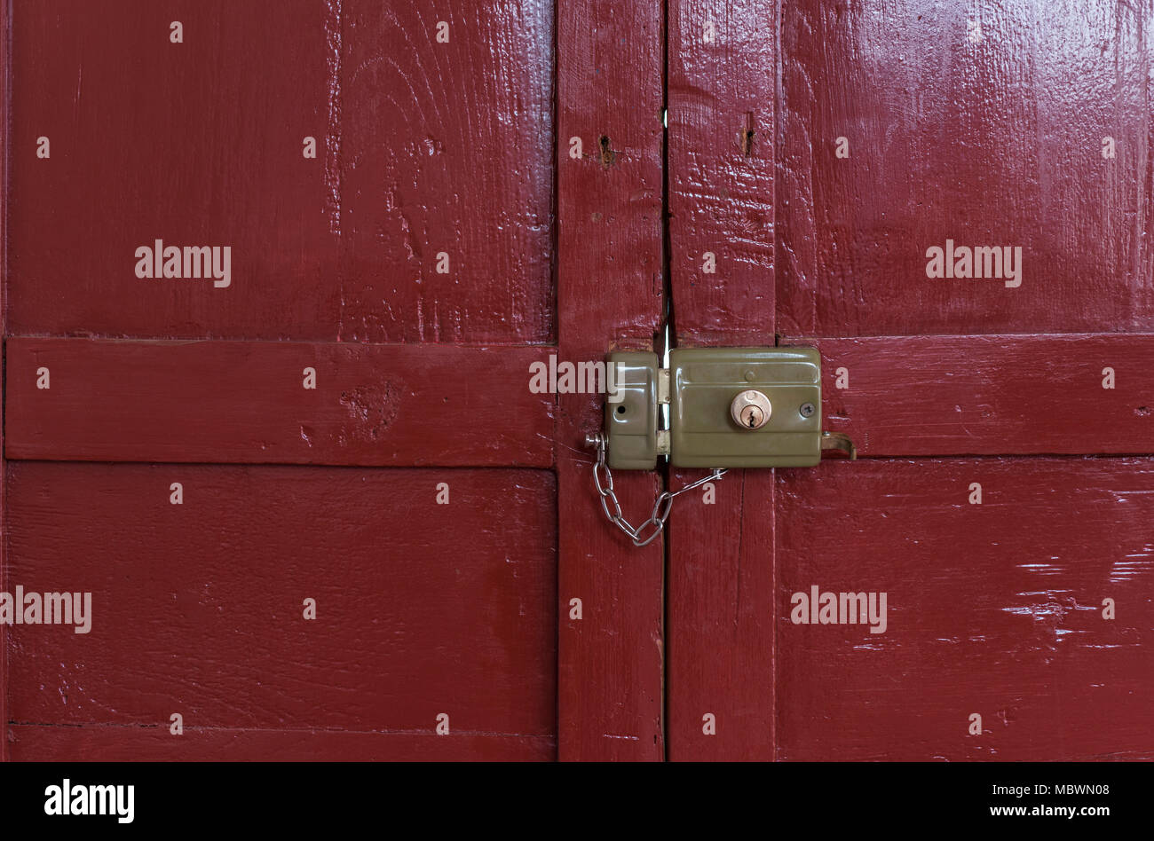 old lock locked with its chain seen from inside an old door painted ... old lock locked with its chain seen from inside an old door painted ...