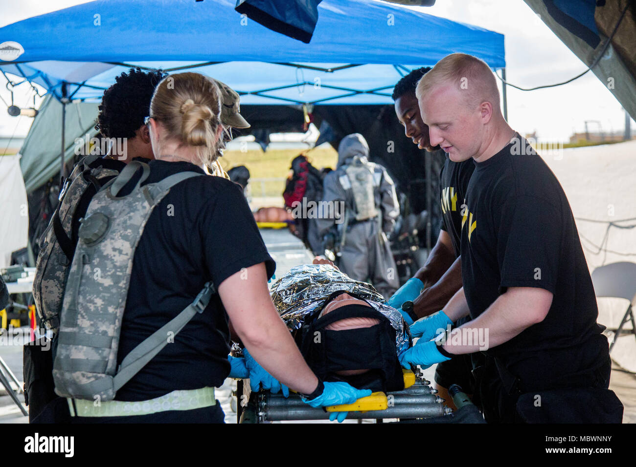 U.S. Army Soldiers of the 414th Chemical Company, exercise a decontamination for a simulated mass chemical attack during a Joint Training Exercise hosted by the Miami-Dade Fire Department and Homestead-Miami Speedway in Miami, Fla. Jan. 11, 2018. This JTE focused on building response capabilities and seamless the transition between the local first responders and the follow-on support provided by the National Guard and Active duty soldiers. (U. S. Army Photo by Spc. P.J. Siquig) Stock Photo