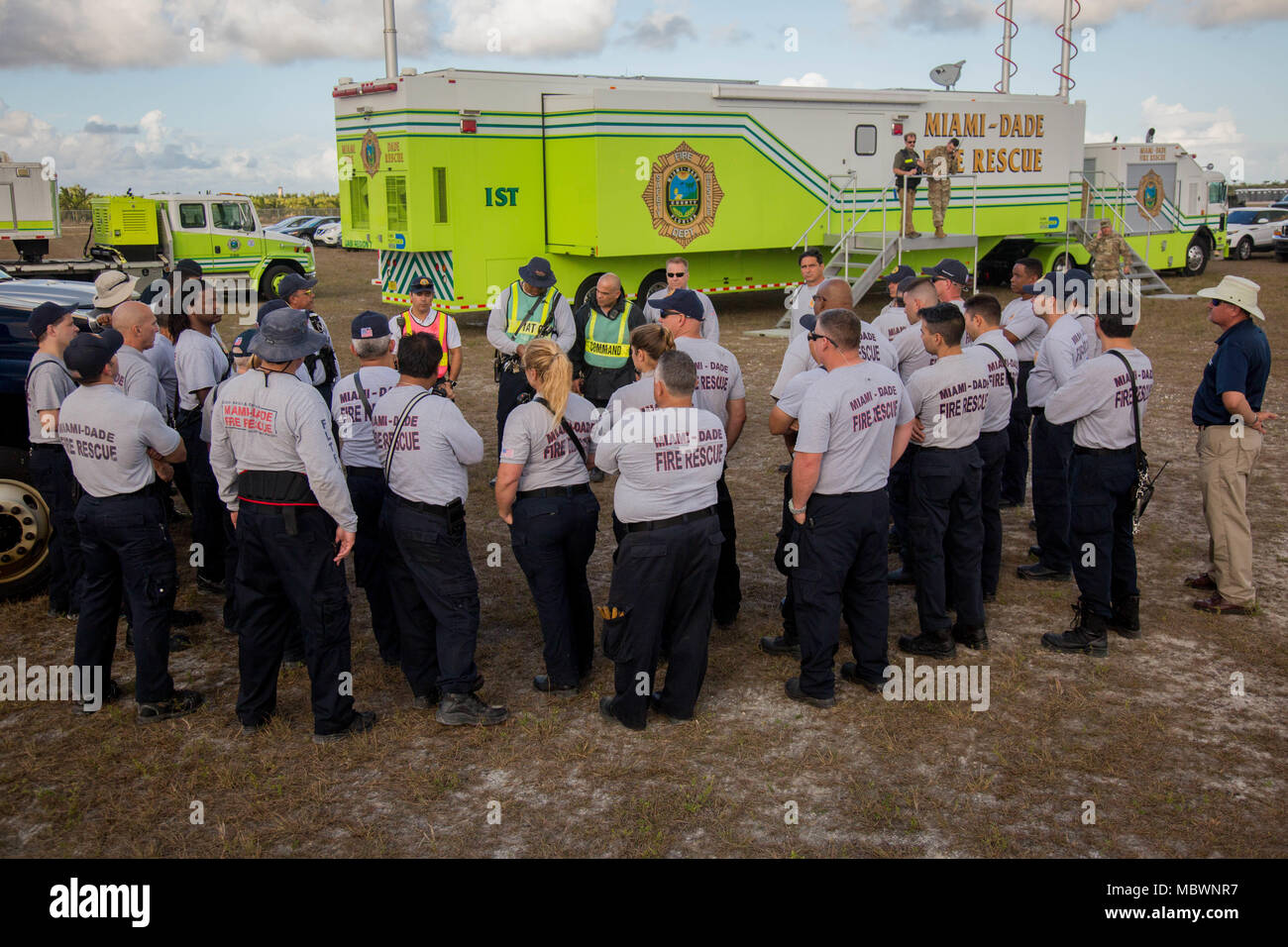 Miami-Dade Fire Department Hazmat members, discuss about the simulated mass chemical attack during a Joint Training Exercise hosted by the Miami-Dade Fire Department and Homestead-Miami Speedway in Miami, Fla. Jan. 11, 2018. This JTE focused on building response capabilities and seamless the transition between the local first responders and the follow-on support provided by the National Guard and Active duty soldiers. (U. S. Army Photo by Spc. P.J. Siquig) Stock Photo