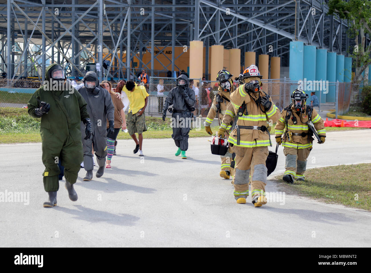 Soldiers of the 414th Chemical Company from Orangeburg, South Carolina and members of the Miami-Dade Fire Department Hazmat team, guide simulated casualties towards a simulated mass casualty decontamination zone during a Joint Training Exercise hosted by the Homestead-Miami Speedway and Miami-Dade Fire Department in Miami, Florida. Jan. 11, 2018. This JTE focused on building response capabilities and the seamless transition between the local first responders and the follow-on support provided by the National Guard and Active duty soldiers. (U. S. Army Photo by Spc. Samuel Brooks) Stock Photo