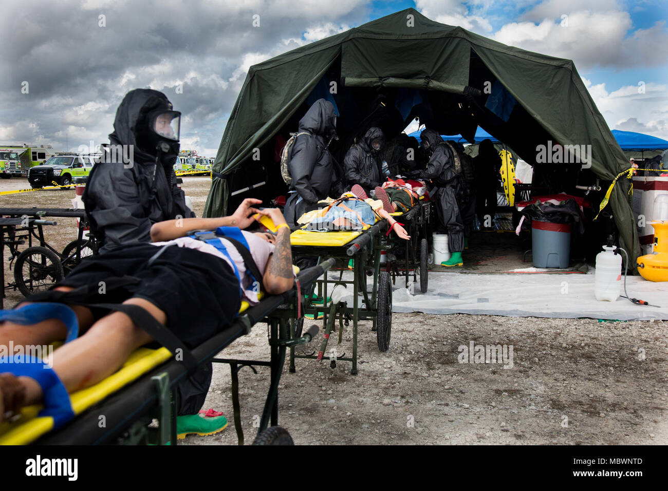 U.S. Army Soldiers of the 414th Chemical Company, exercise a decontamination for a simulated mass chemical attack during a Joint Training Exercise hosted by the Miami-Dade Fire Department and Homestead-Miami Speedway in Miami, Fla. Jan. 11, 2018. This JTE focused on building response capabilities and seamless the transition between the local first responders and the follow-on support provided by the National Guard and Active duty soldiers. (U. S. Army Photo by Spc. P.J. Siquig) Stock Photo