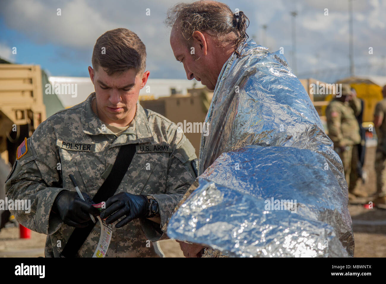 U.S. Army Sgt. Austin Polster of the 409th Area Support Medical Company, triage a casualty for a simulated mass chemical attack during a Joint Training Exercise hosted by the Miami-Dade Fire Department and Homestead-Miami Speedway in Miami, Fla. Jan. 11, 2018. This JTE focused on building response capabilities and seamless the transition between the local first responders and the follow-on support provided by the National Guard and Active duty soldiers. (U. S. Army Photo by Spc. P.J. Siquig) Stock Photo
