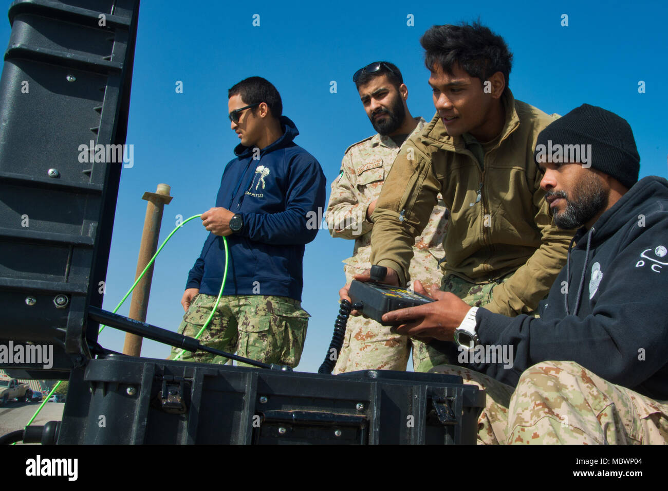 180108-N-XE158-0120 Mohammed Al-Ahmad Naval Base, KUWAIT (Jan. 8, 2018) Explosive Ordnance Disposal Technician 2nd Class Veranio Xavier Tongson, second from right, assigned to Commander, Task Group 56.1, provides hands-on training on a remotely operated vehicle with a Kuwait Naval Force explosive ordnance disposal technician during a training evolution as part of exercise Eager Response 18. Eager Response 18 is a bilateral explosive ordnance disposal military exercise between the State of Kuwait and the United States. The exercise fortifies military-to-military relationships between the Kuwait Stock Photo