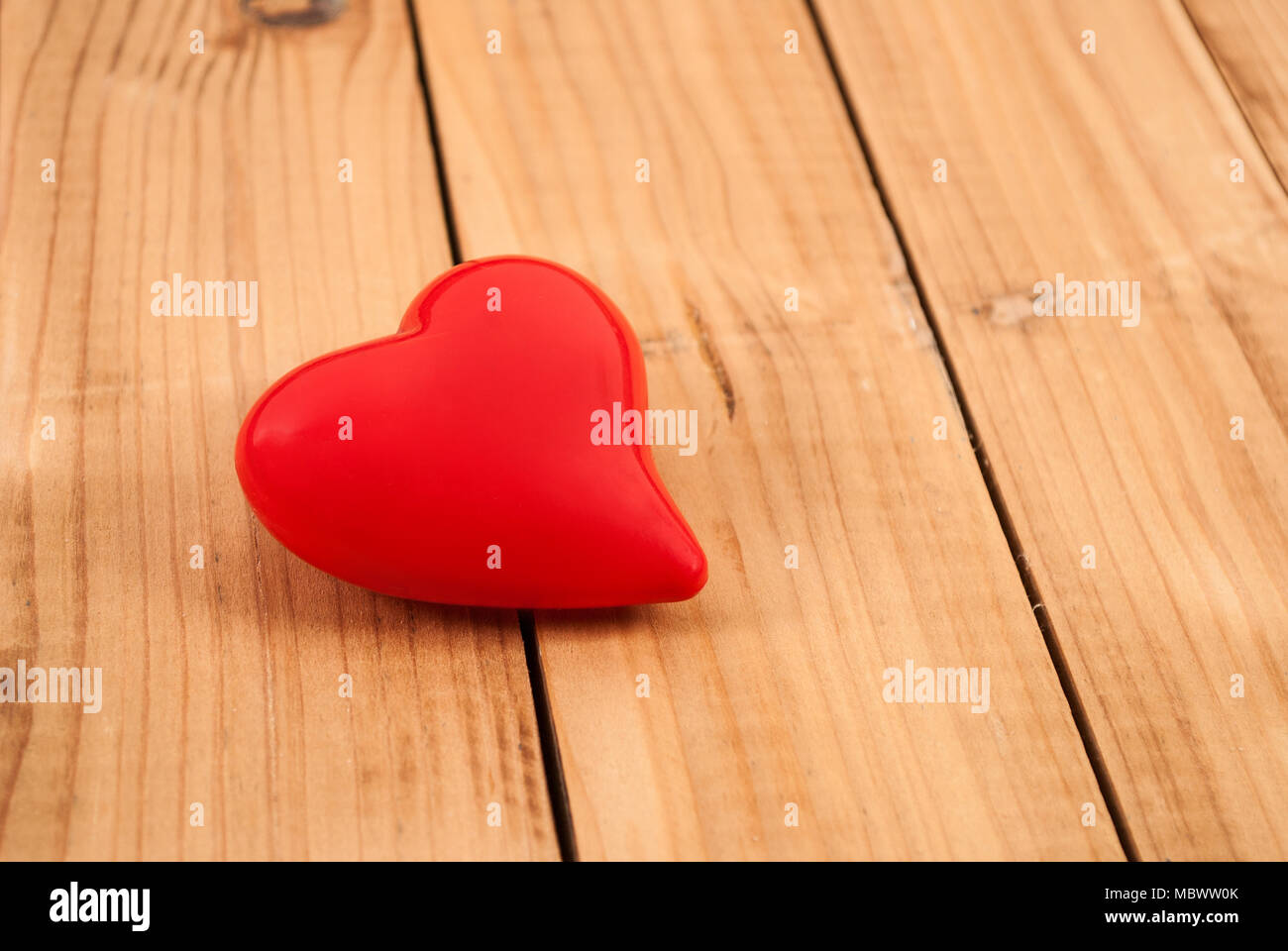 Red heart on wood background for Valentines Day Stock Photo - Alamy