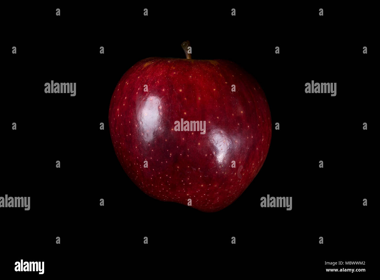 Red apple with light reflections, on black background Stock Photo - Alamy