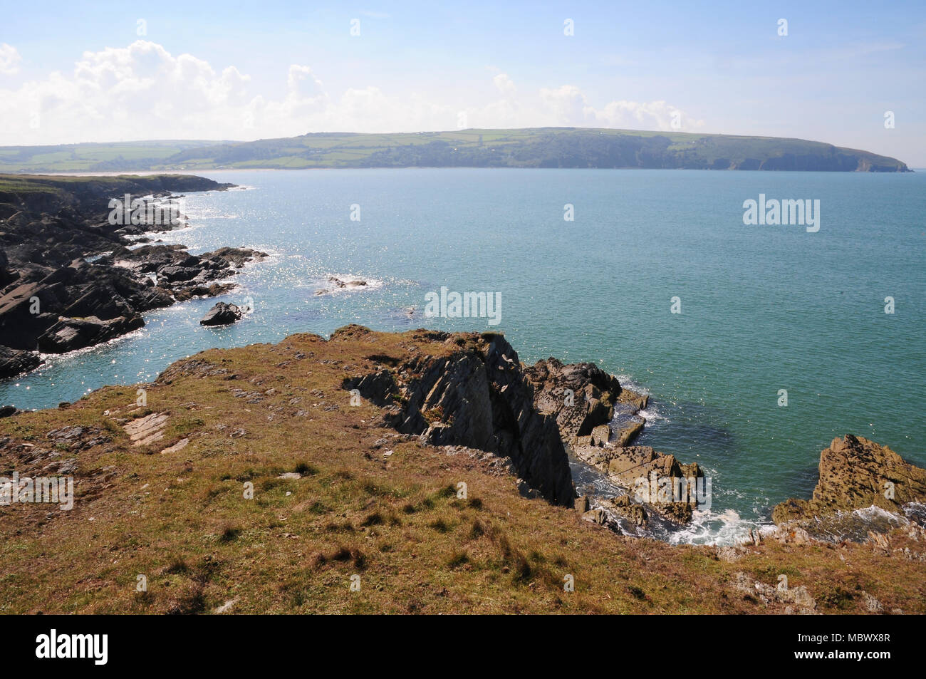 landscape shot over rocky cliffs across the bay to a headland opposite Stock Photo