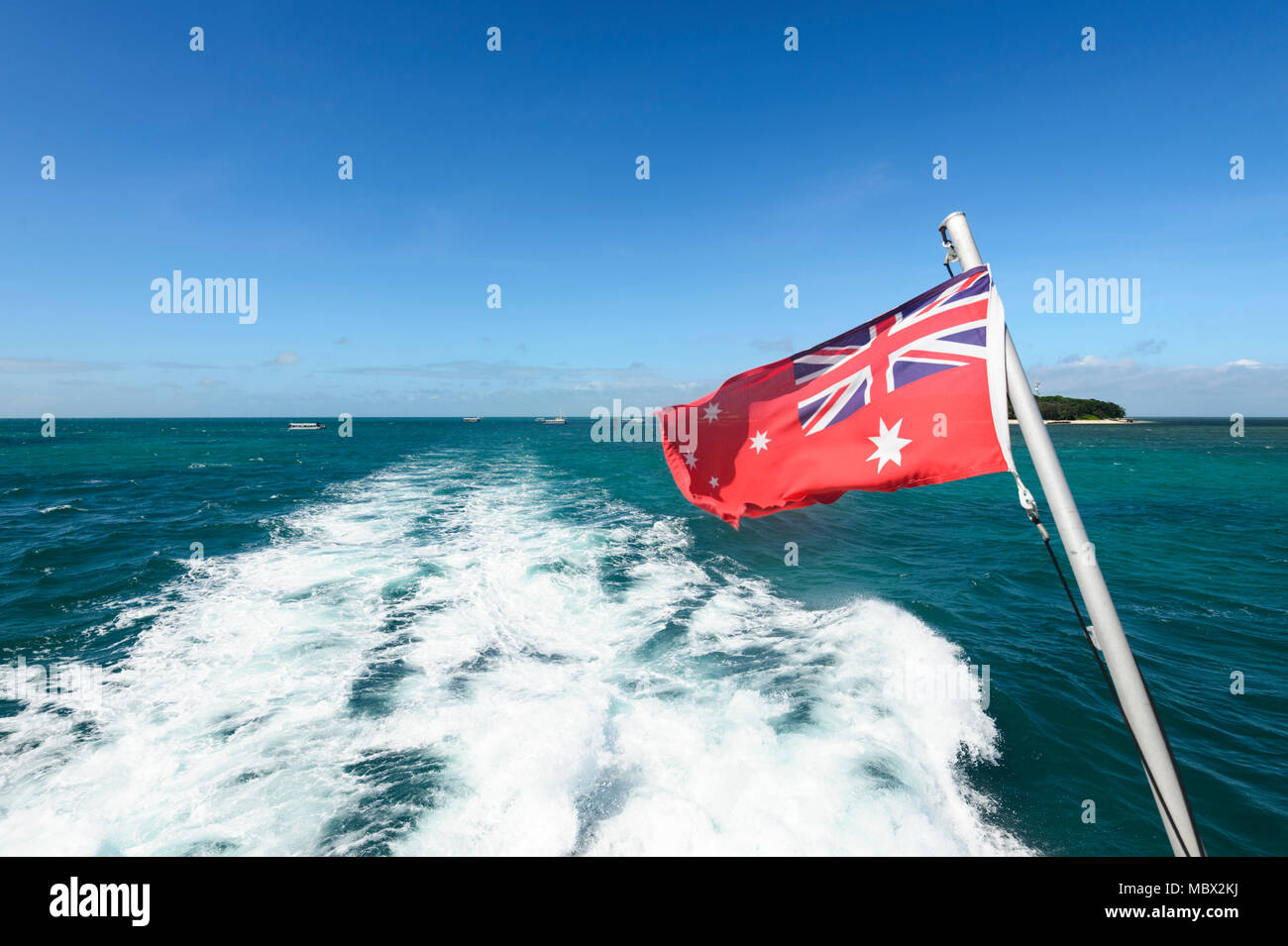 Boat wake and the Australian flag, Great Barrier Reef, Far North Queensland, QLD, FNQ, Australia Stock Photo