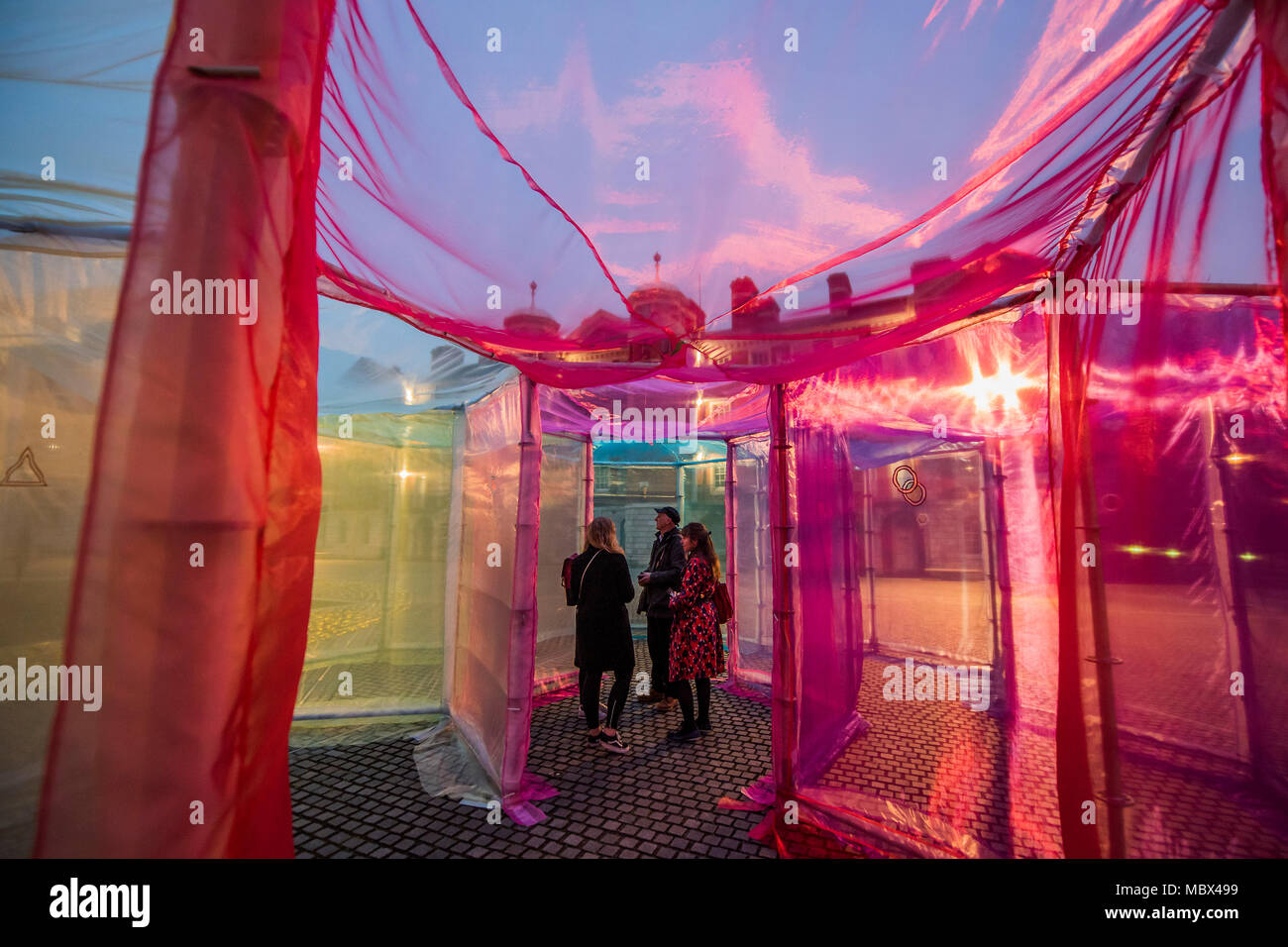 London, UK. 11th April 2018. The Inevitable by multi media Artist Sally Buchanan as part of this year’s The Flux Exhibition, on the Rootstein Hopkins Parade Ground of Chelsea College of The Arts. An outdoor interactive installation, consisting of over 220 metres of Organza and 25 yards of Crinoline fabric allowing visitors to walk through a simple series of 10 interlinked hexagonal compartments. It will be there from 11th – 15th April 2018. Credit: Guy Bell/Alamy Live News Stock Photo
