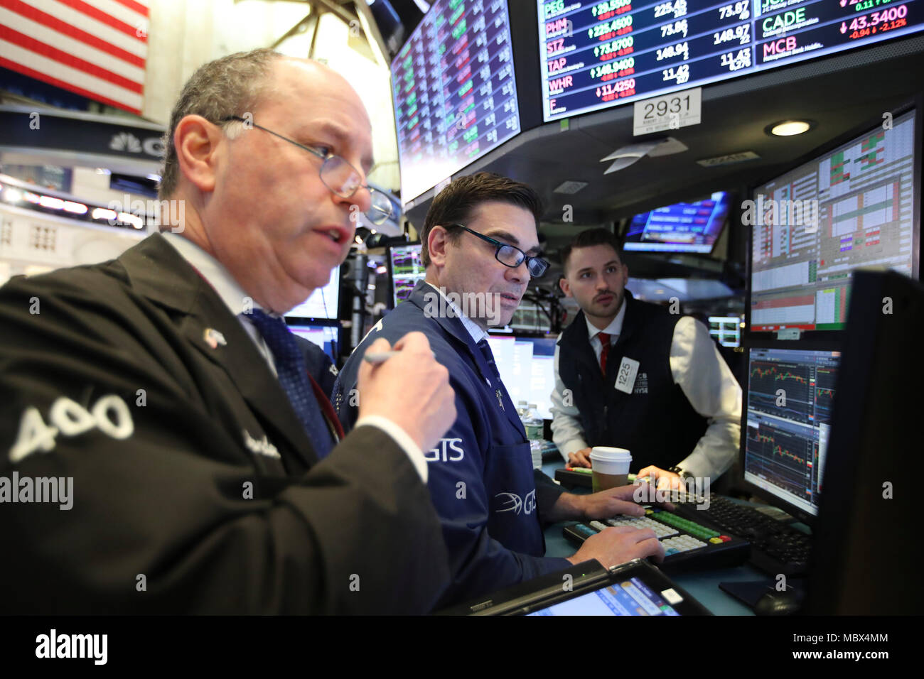 New York, USA. 11th Apr, 2018. Traders work at the New York Stock Exchange in New York, the United States, April 11, 2018. U.S. stocks closed lower on Wednesday. The Dow decreased 0.90 percent to 24,189.45, and the S&P 500 erased 0.55 percent to 2,642.19, while the Nasdaq lost 0.36 percent to 7,069.03. Credit: Wang Ying/Xinhua/Alamy Live News Stock Photo