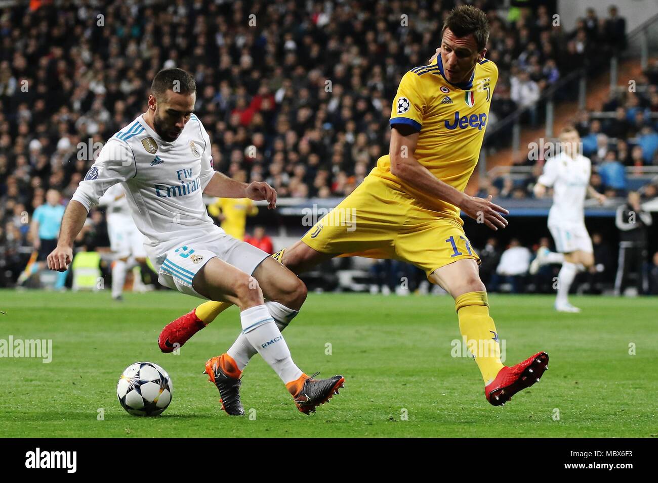 Madrid, Spain. 11th Apr, 2018. Real Madrid's Dani Carvajal (L) vies with Juventus' Mandzukic during the UEFA Champions League quarterfinal second leg soccer match between Spanish team Real Madrid and Italian team Juventus in Madrid, Spain, on April 11, 2018. Juventus won 3-1. Real Madrid advanced to the semifinal with 4-3 on aggregate. Credit: Edward Peters Lopez/Xinhua/Alamy Live News Stock Photo