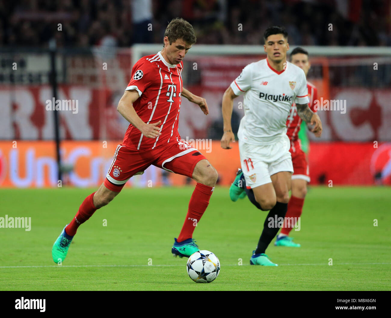 Munich, Germany. 11th Apr, 2018. Bayern Munich's Thomas Mueller (L) competes during the UEFA Champions League quarterfinal second leg soccer match between Bayern Munich of Germany and FC Sevilla of Spain in Munich, Germany, on April 11, 2018. The match ended 0-0 and Bayern Munich advanced to the semifinal with 2-1 on aggregate. Credit: Philippe Ruiz/Xinhua/Alamy Live News Stock Photo
