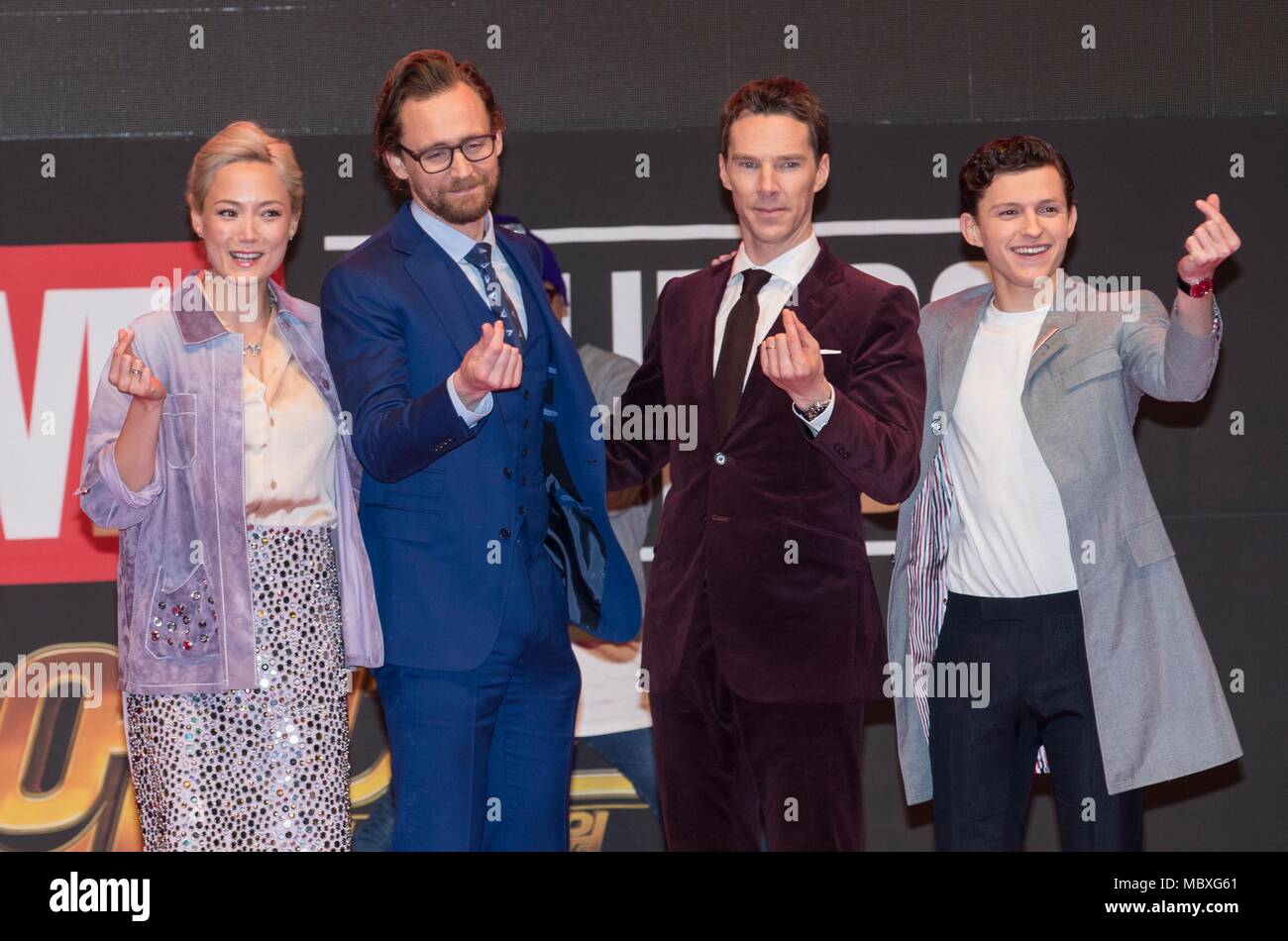 Seoul, South Korea. 12th Apr, 2018. Cast members of 'Avengers: Infinity War' Pom Klementieff, Tom Hiddleston, Benedict Cumberbatch and Tom Holland (from L to R) cross their fingers to form the heartshape to fans during a promotion event for the film in Seoul, South Korea, April 12, 2018. Credit: Lee Sang-ho/Xinhua/Alamy Live News Stock Photo