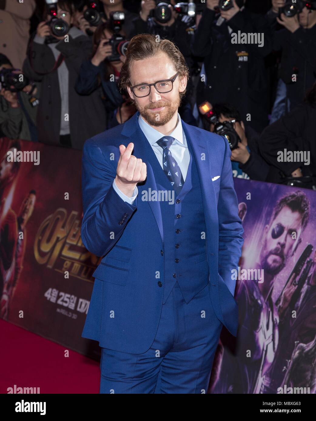 Seoul, South Korea. 12th Apr, 2018. Tom Hiddleston crosses his fingers to form a heart shape to fans during a promotion event of 'Avengers: Infinity War' in Seoul, South Korea, April 12, 2018. Credit: Lee Sang-ho/Xinhua/Alamy Live News Stock Photo