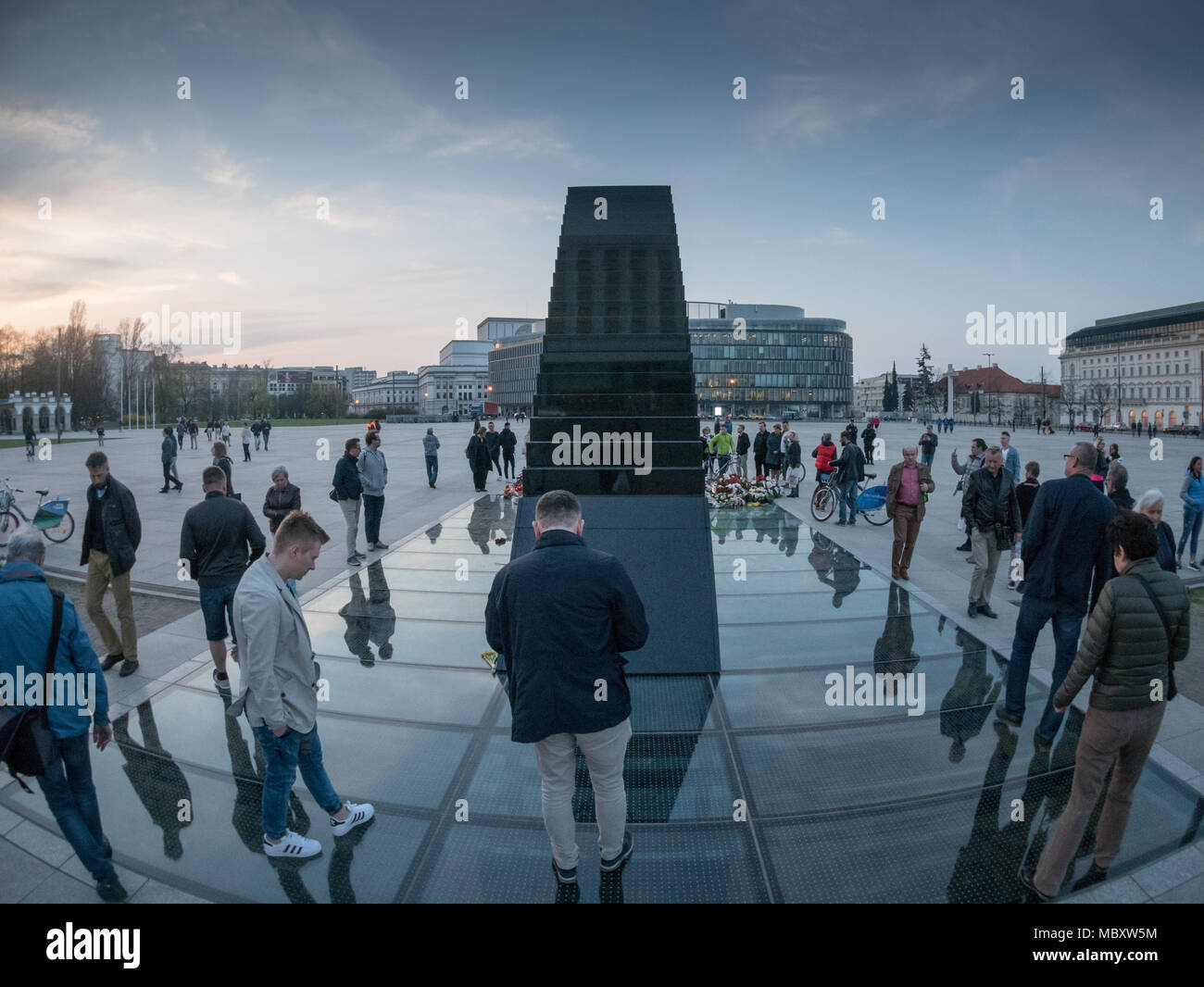 People are gathering around the newly unveiled monument to the Victims of the Smolensk Plane Crash, Warsaw, Poland Stock Photo
