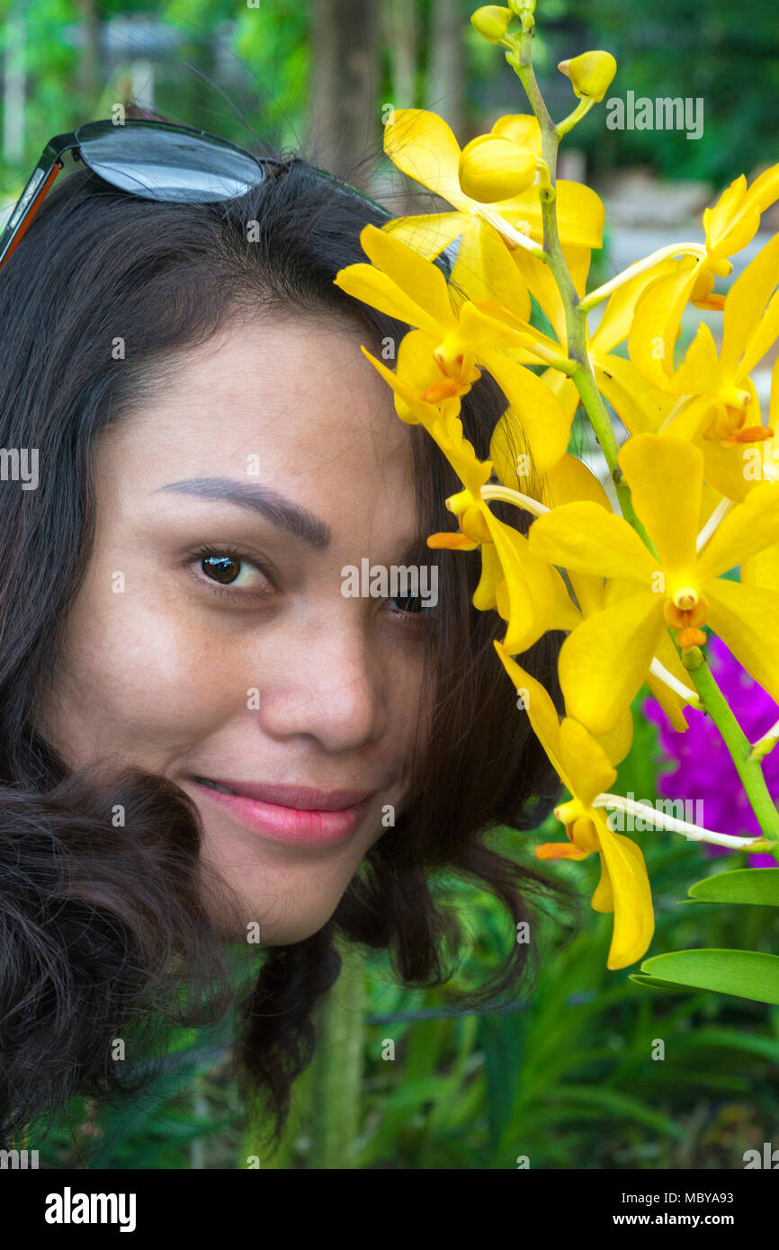 Thai girl posing at orchid farm, Thon Buri, Bangkok, Thailand Stock Photo
