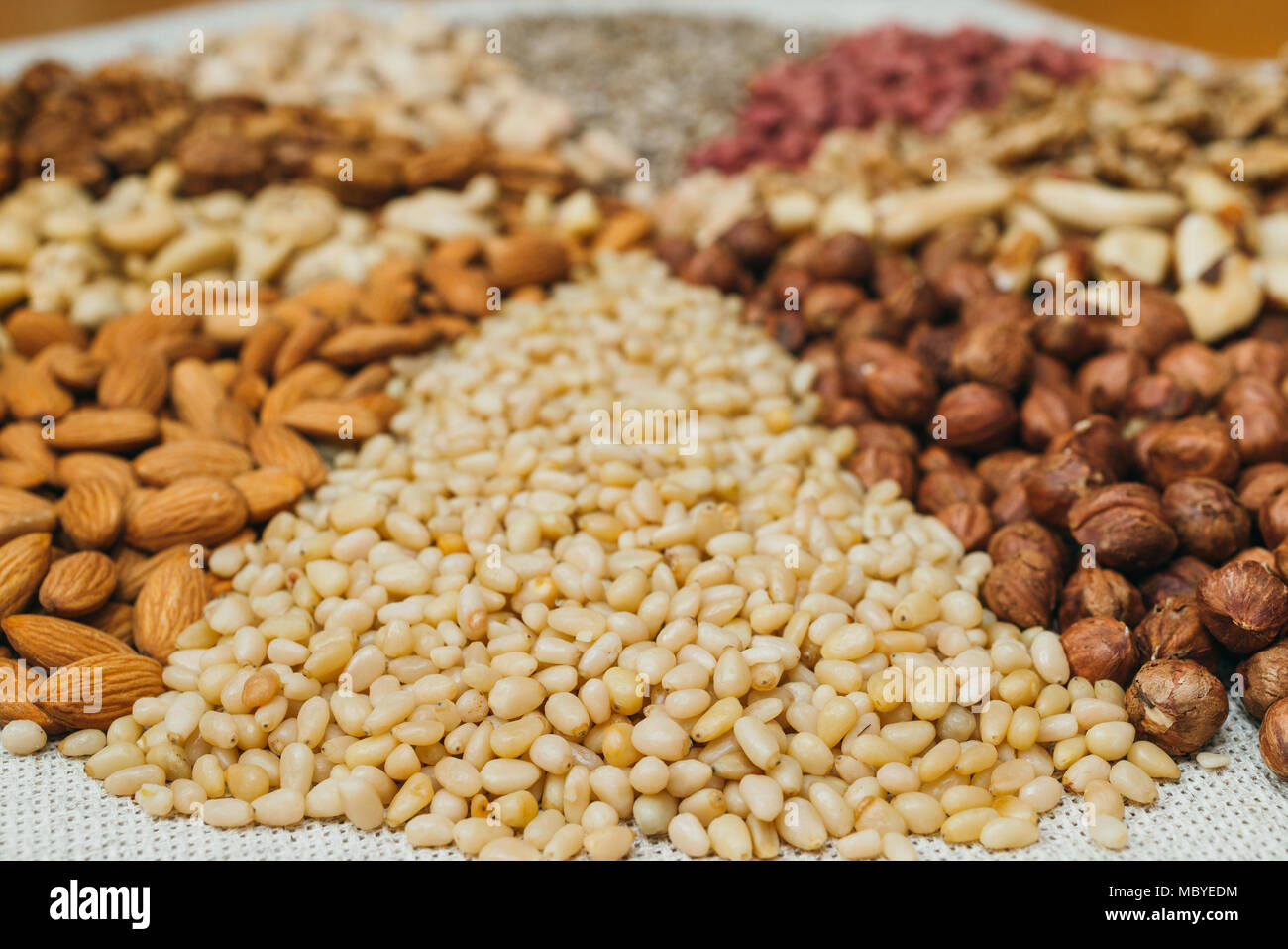 Nuts mix in a canvas bag in table. Kinds of nuts pecan, brazil, cedar
