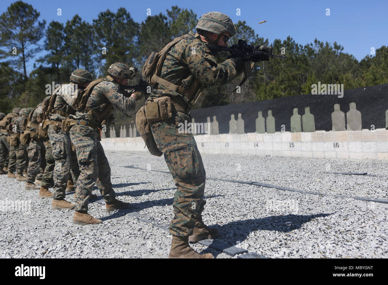 U.S. Marines with 2nd Marine Division, rehearse close quarters firing techniques from the 15, 10, five and three yard firing line during a range as part of a close quarter’s tactics enabler’s course at Camp Lejeune, N.C., March 23, 2018. The course provided Marines the opportunity to improve fire and movement tactics as a security platoon element. Marines participated in the training in preparation for their upcoming deployment with 22nd Marine Expeditionary Unit. Stock Photo