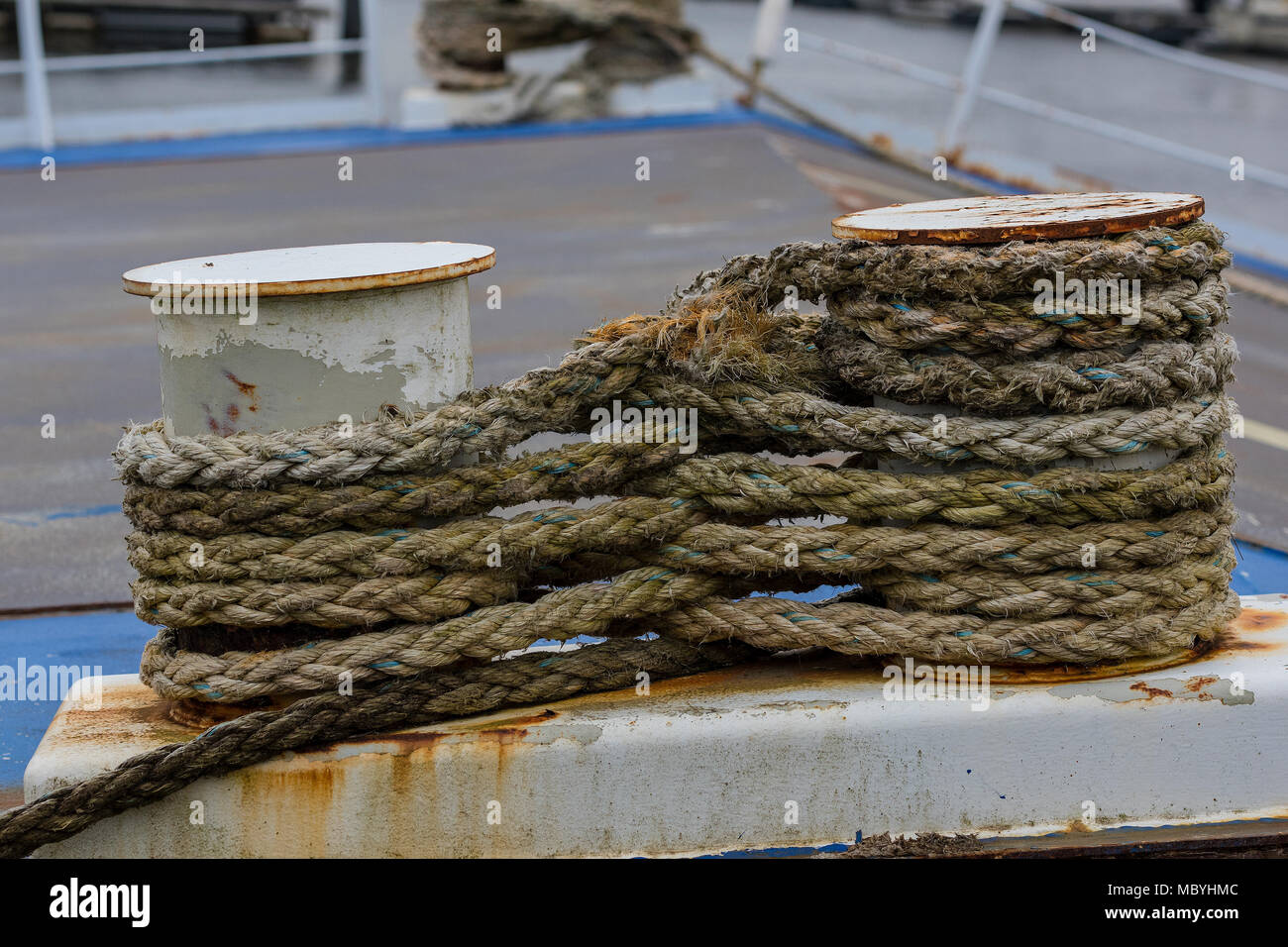 some ropes wrapped around two bollards on the quayside of a ship in ...