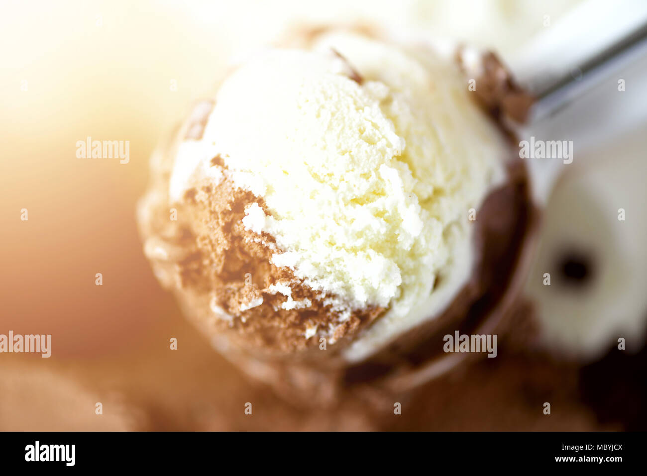 Scooped vanilla and chocolate ice cream background. Summer food concept, copy space, top view. Sweet yogurt dessert or brown ice-cream texture. Stock Photo
