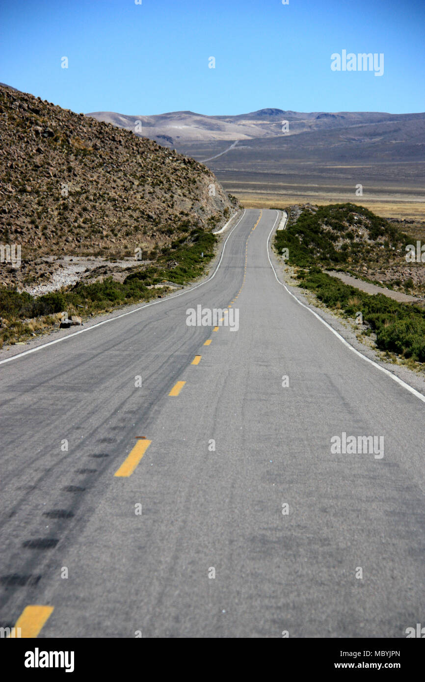 Typical Road in the high elevated plains of the Andes, Peru Stock Photo