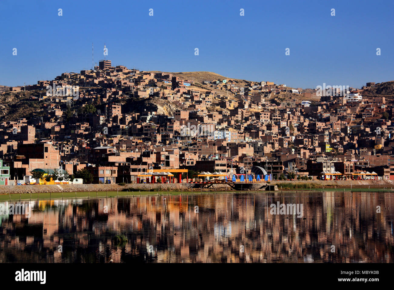City of Puno reflecting on Lake Titicaca in Peru Stock Photo