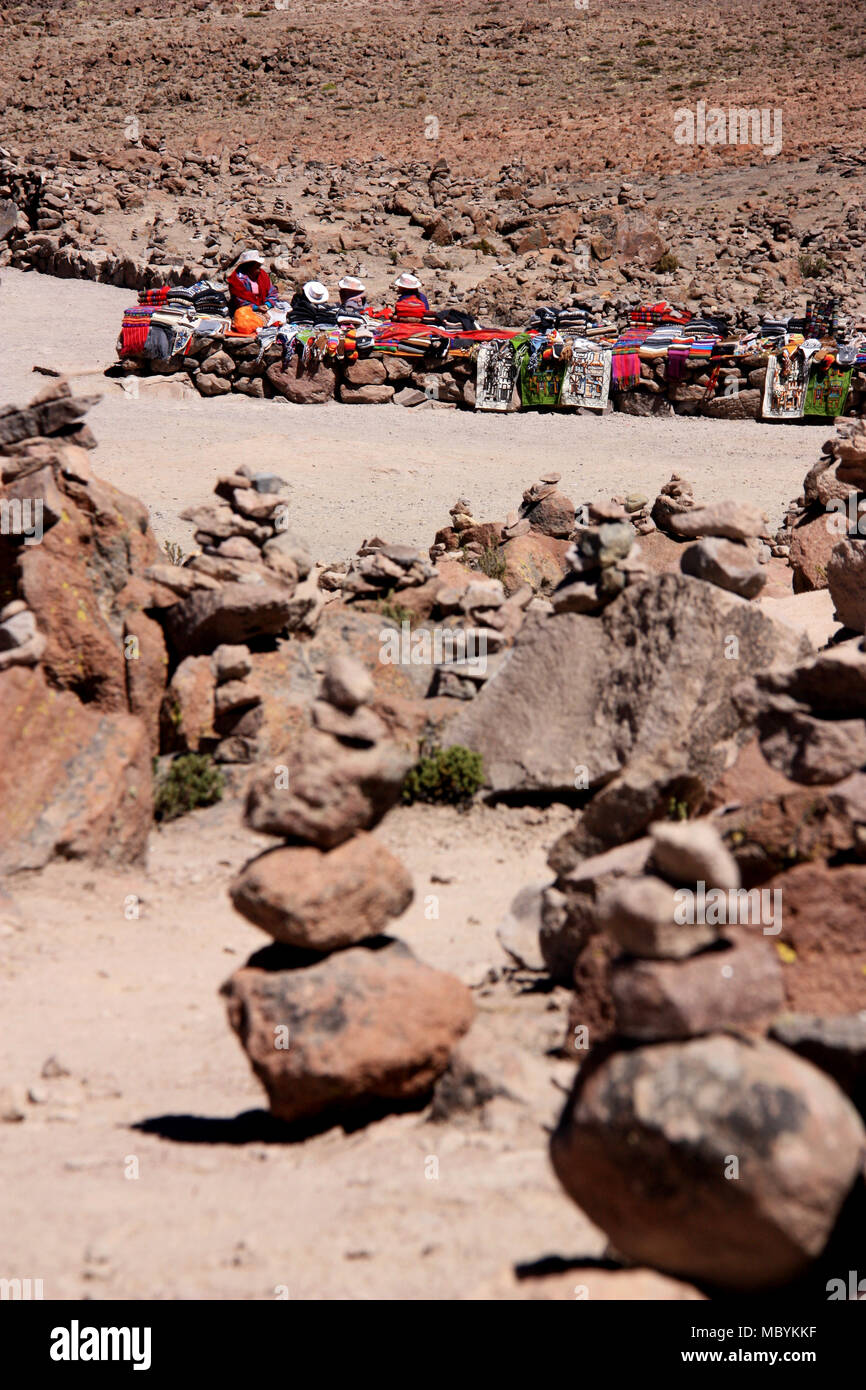 Peruvian Women selling traditional Textiles on Top of a high Mountain Pass in the Andes Stock Photo