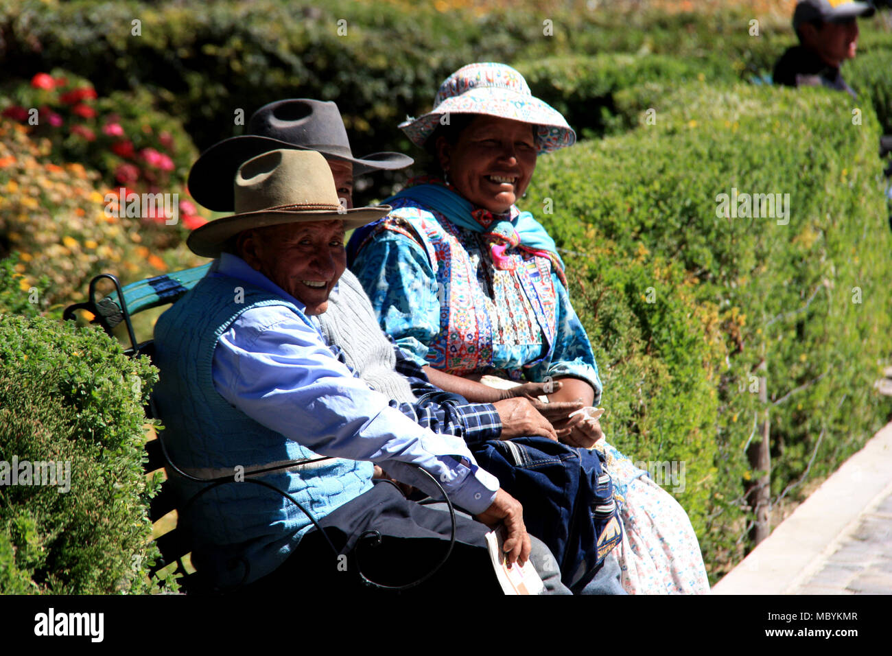 Traditionally dressed elderly People sitting on a Bench in Chivay, Peru Stock Photo