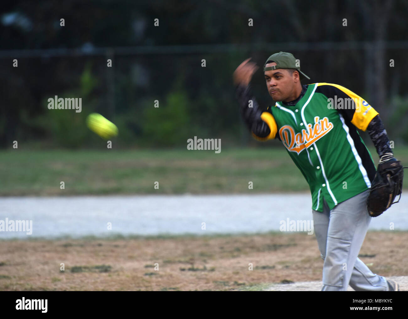U.S. Marine Corps Reserve Sgt. Geovanni Rivera, 346th Air Expeditionary Group civil affairs team member, tosses a softball during a game in Meteti, Panama, March 28, 2018, during exercise New Horizons 2018. Rivera deployed to the 346th AEG, but is a member of the 4th Civil Affairs Group based out of Miami, Fla., and has participated in nine New Horizons exercises throughout Central America. During the exercise, aimed at training U.S. military members and assisting partner nations, exercise personnel also spend down time playing sports, participating in local events and interacting with locals Stock Photo