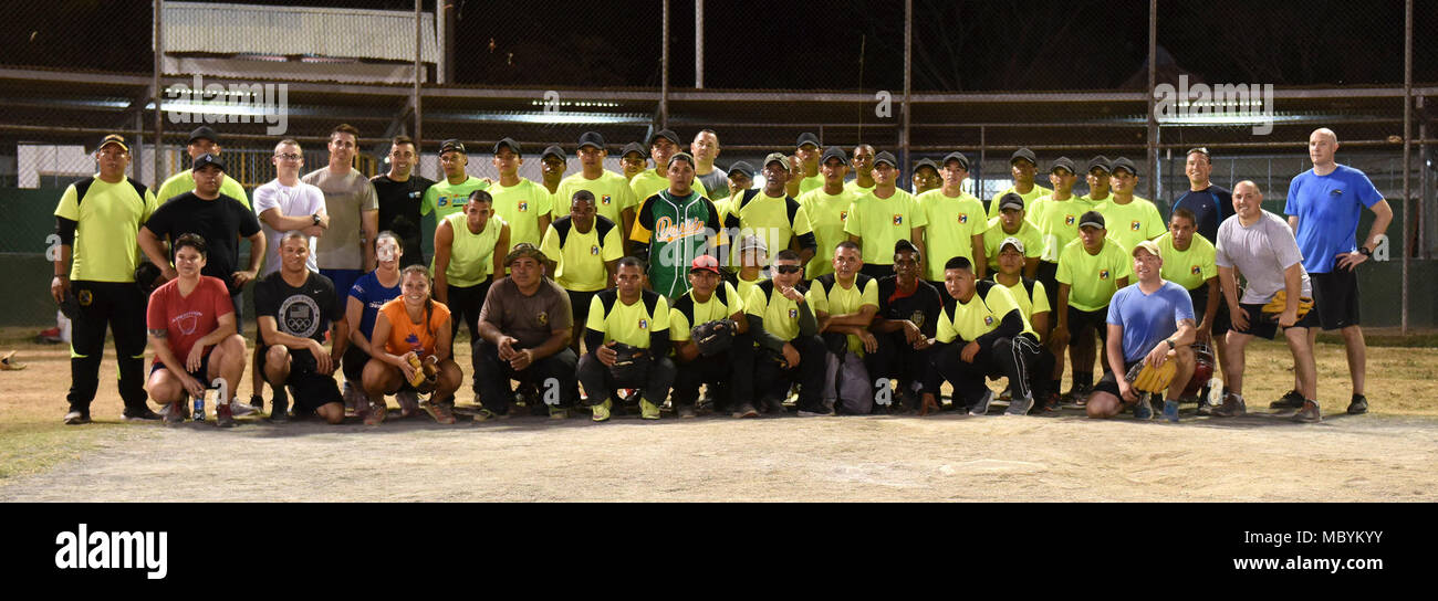 Members of the 346th Air Expeditionary Group and members of the Panamanian military and police force known as SENAFRONT, group up for a photo after a softball game during exercise New Horizons 2018 April 1, 2018, in Meteti, Panama. The softball game provided a fun activity for members of both originations and also helped boost camaraderie between military members in both partner nations. Stock Photo