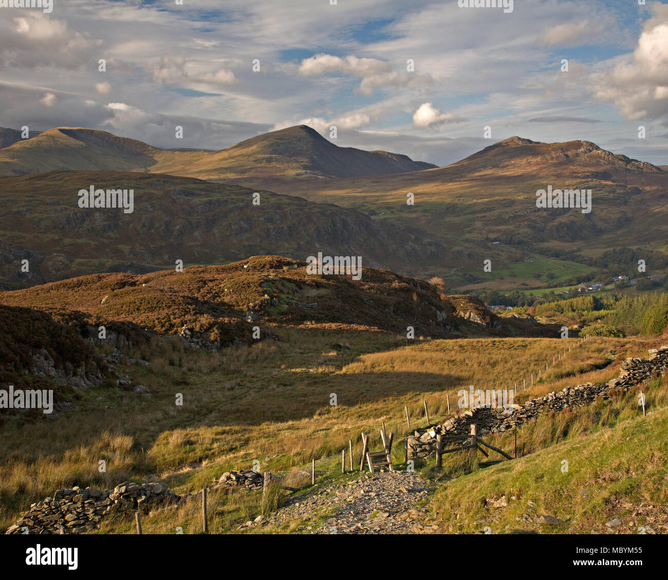 Drystone wall and mountains at Moel Siabod, Snowdonia, North Wales on a sunny day with clouds Stock Photo