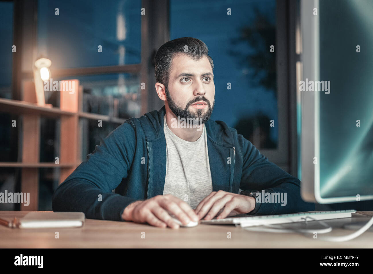 Earnest IT guy checking code Stock Photo