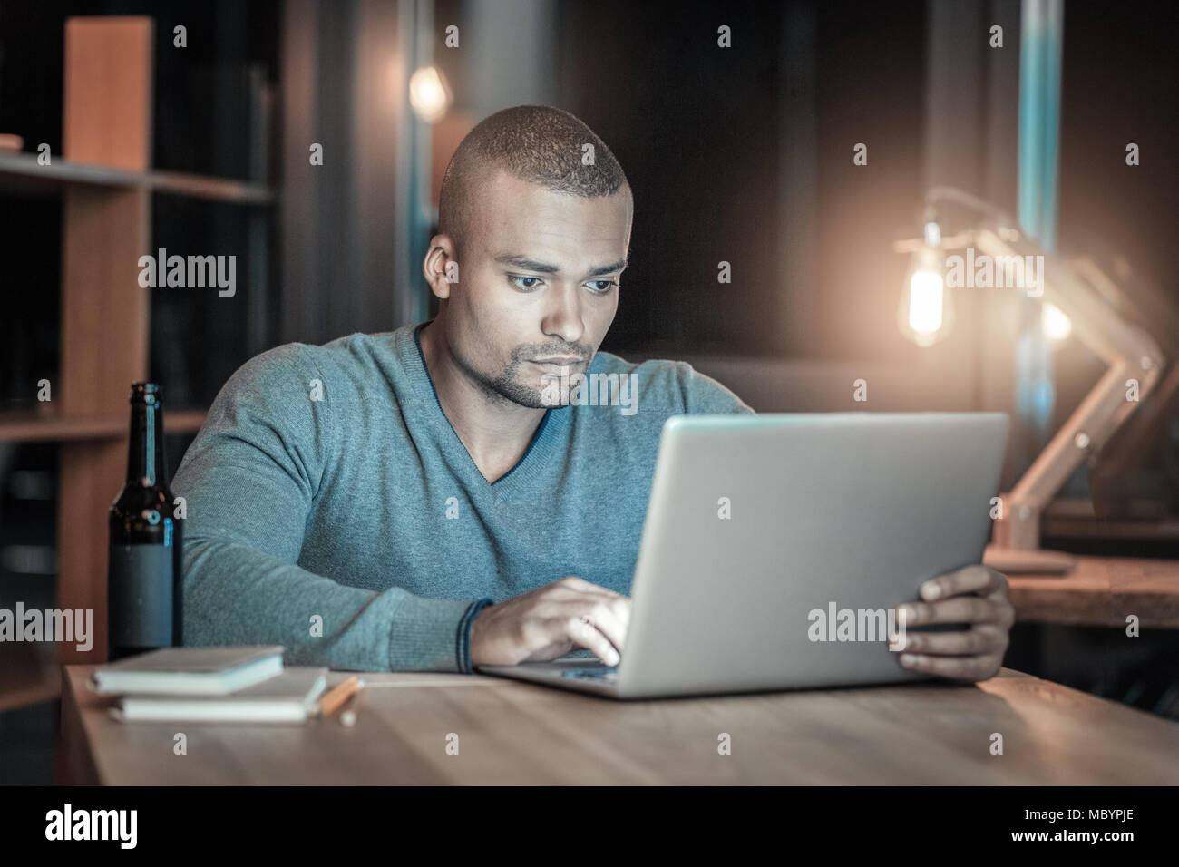 Handsome IT guy testing new laptop Stock Photo