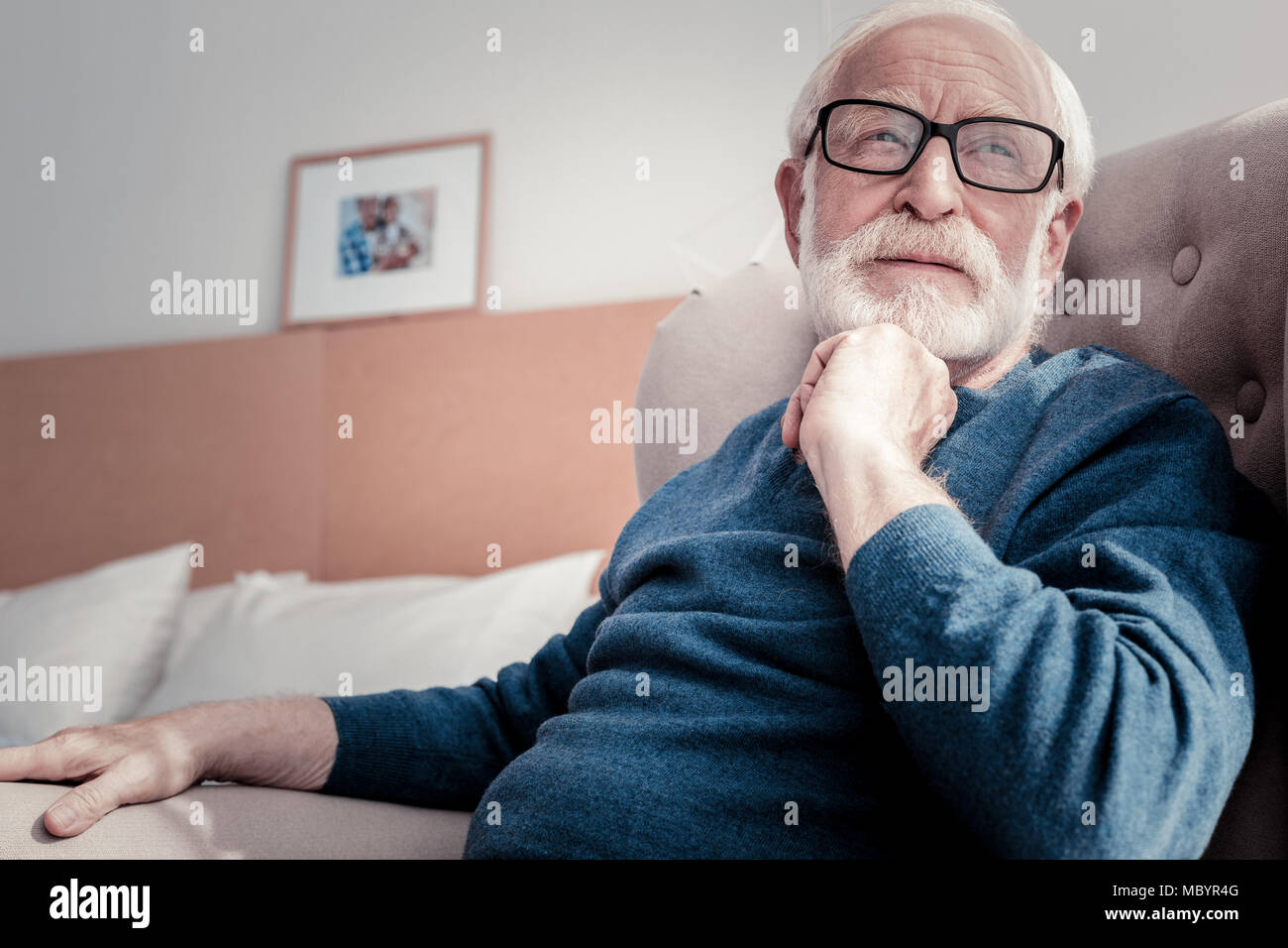 Thoughtful retired man sitting hi-res stock photography and images - Alamy