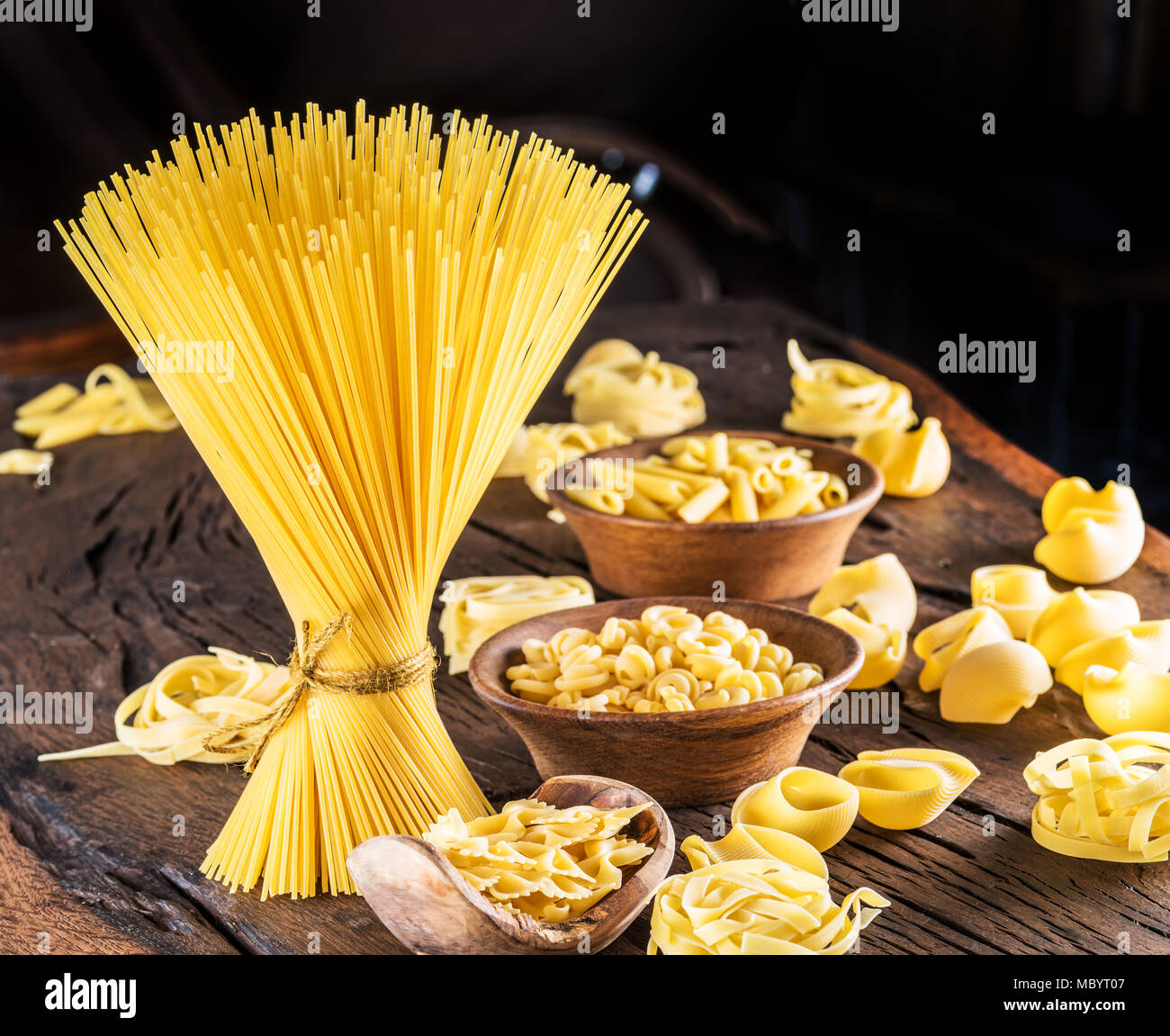 Different pasta types on wooden table. Stock Photo