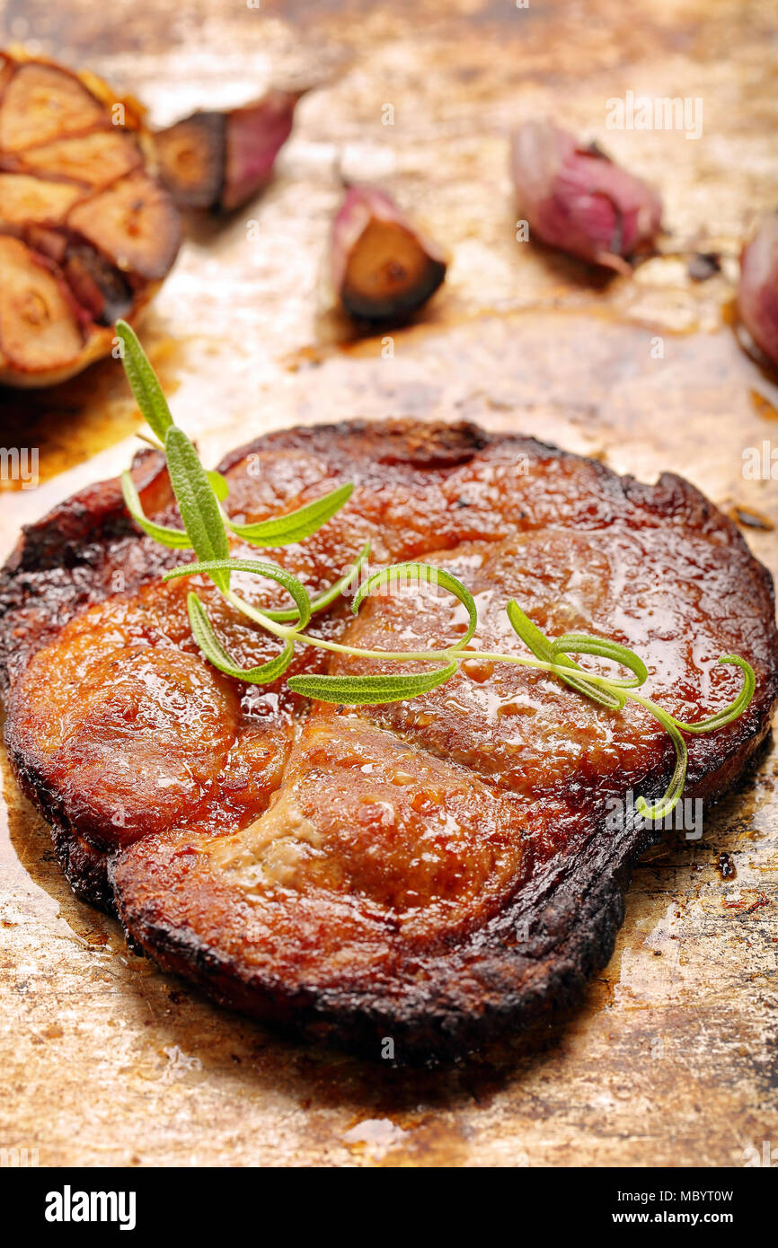 Fried grilled pork neck with garlic on rustic background Stock Photo