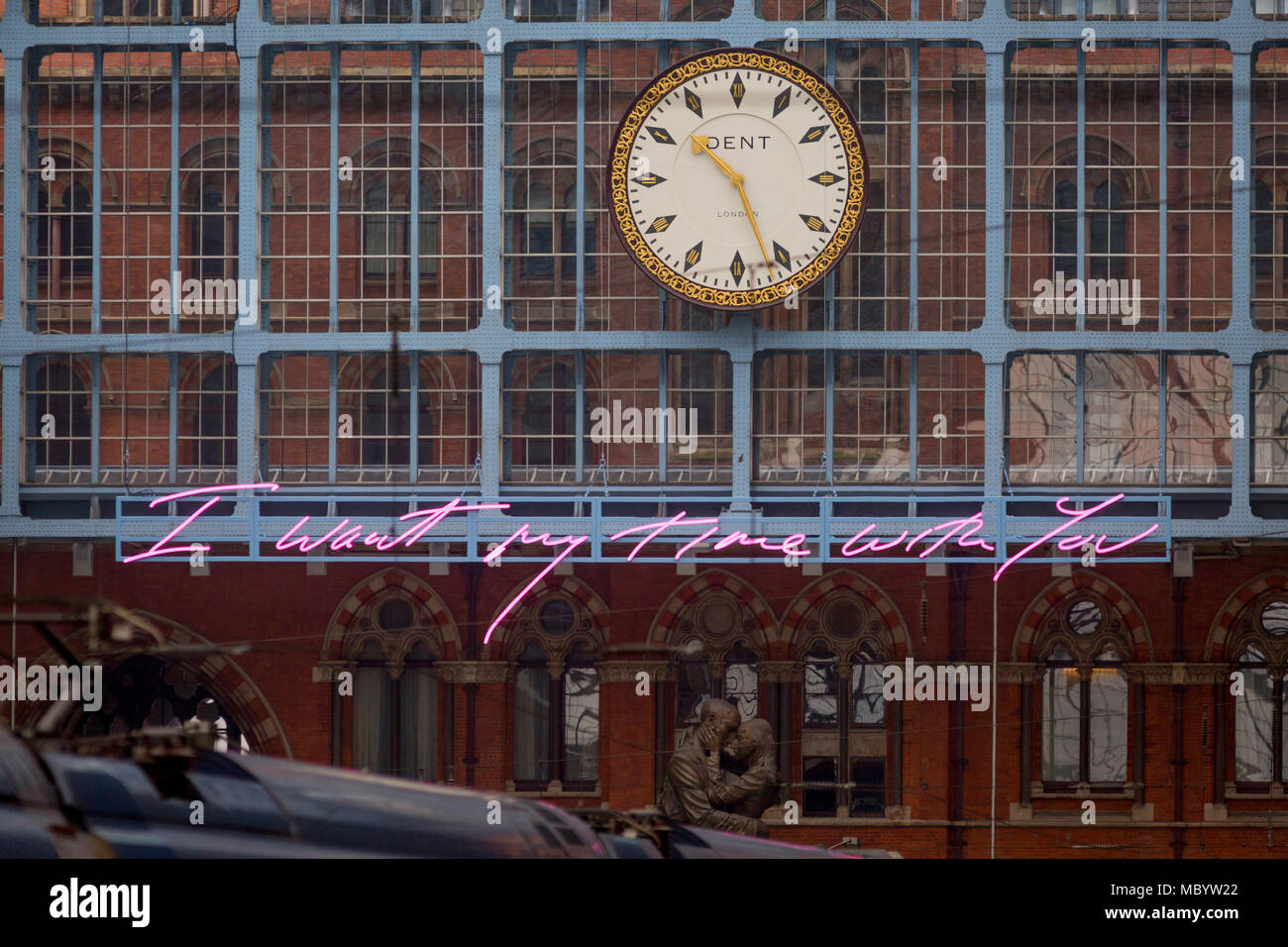 The new artwork entitled 'I Want My Time With You' by British (Britpop) artist Tracy Emin hangs over the main concourse at St. Pancras Station, on 10th April 2018, in London, England. In the sixth year of the Terrace Wires Commission - and in celebration of the 150th anniversary of St Pancras International and the 250th anniversary of the Royal Academy of Arts, at one of London's mainline station, the London hub for Eurostar - the 20 metre-long greeting to commuters reads 'I Want My Time With You' and Emin thinks that arriving by train and being met by a lover as they put their arms around the Stock Photo