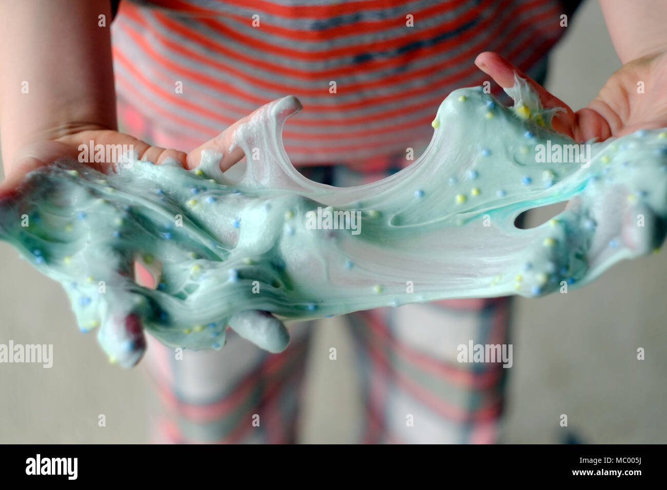 Child with home made slime. The new craze uses borax and PVA glue and paint  to make colourful mixtures Stock Photo - Alamy